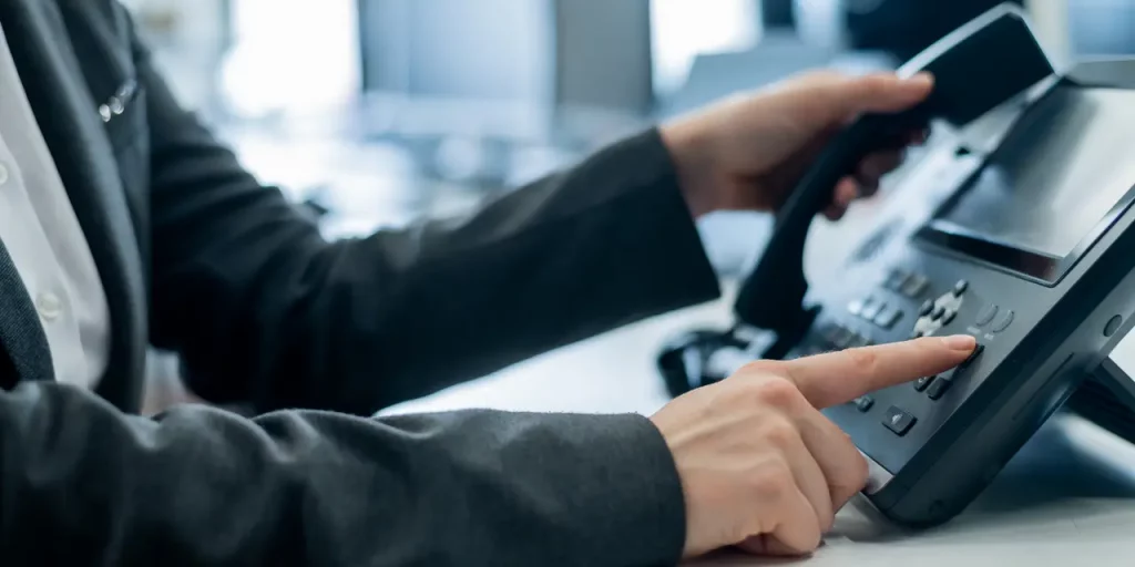 a person using a telephone